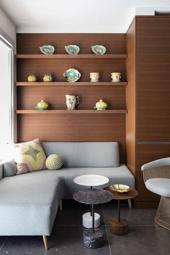 Banquette seating interior design in Beekman Place Townhouse New York City by Andrew Suvalsky Designs with vintage plates.