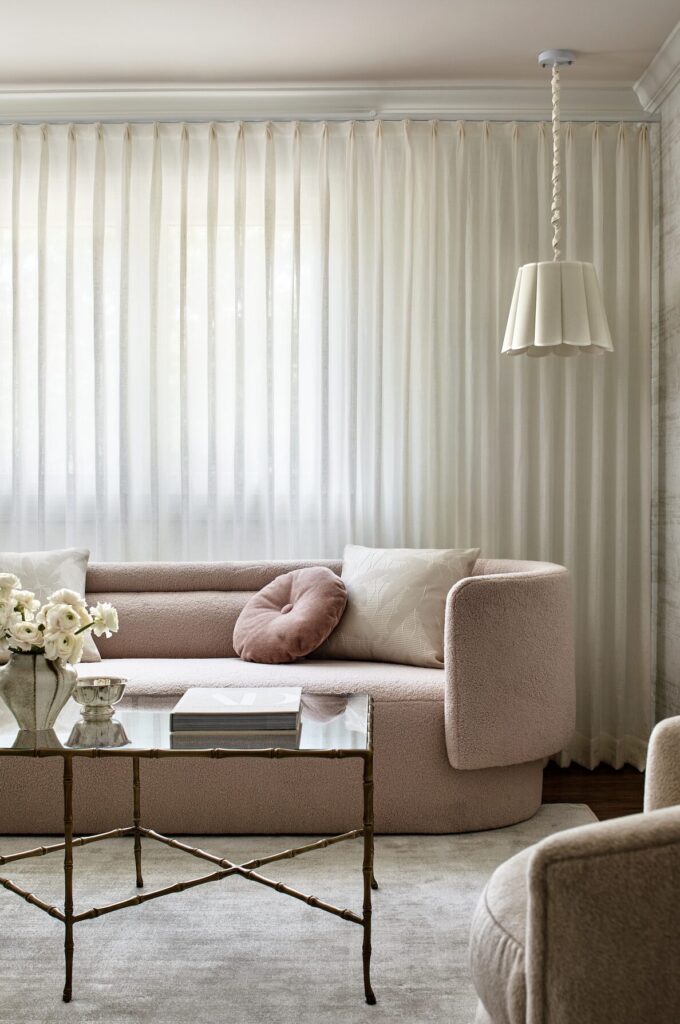 Strategic lighting design detail in a soft, pink and ivory living room, designed by Andrew Suvalsky. 